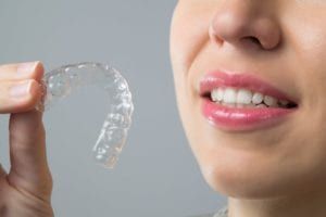 Girl with Invisalign in hand
